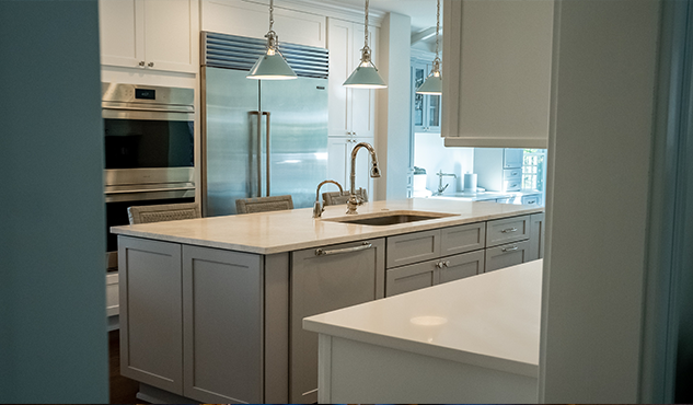 White kitchen + brass island
